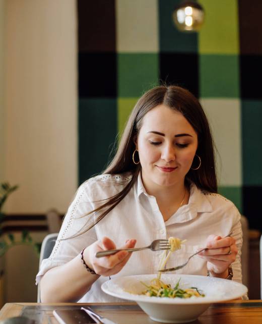 Friends enjoying lunch in the restaurant, eating paste